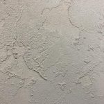 A white wall with some kind of paint on it